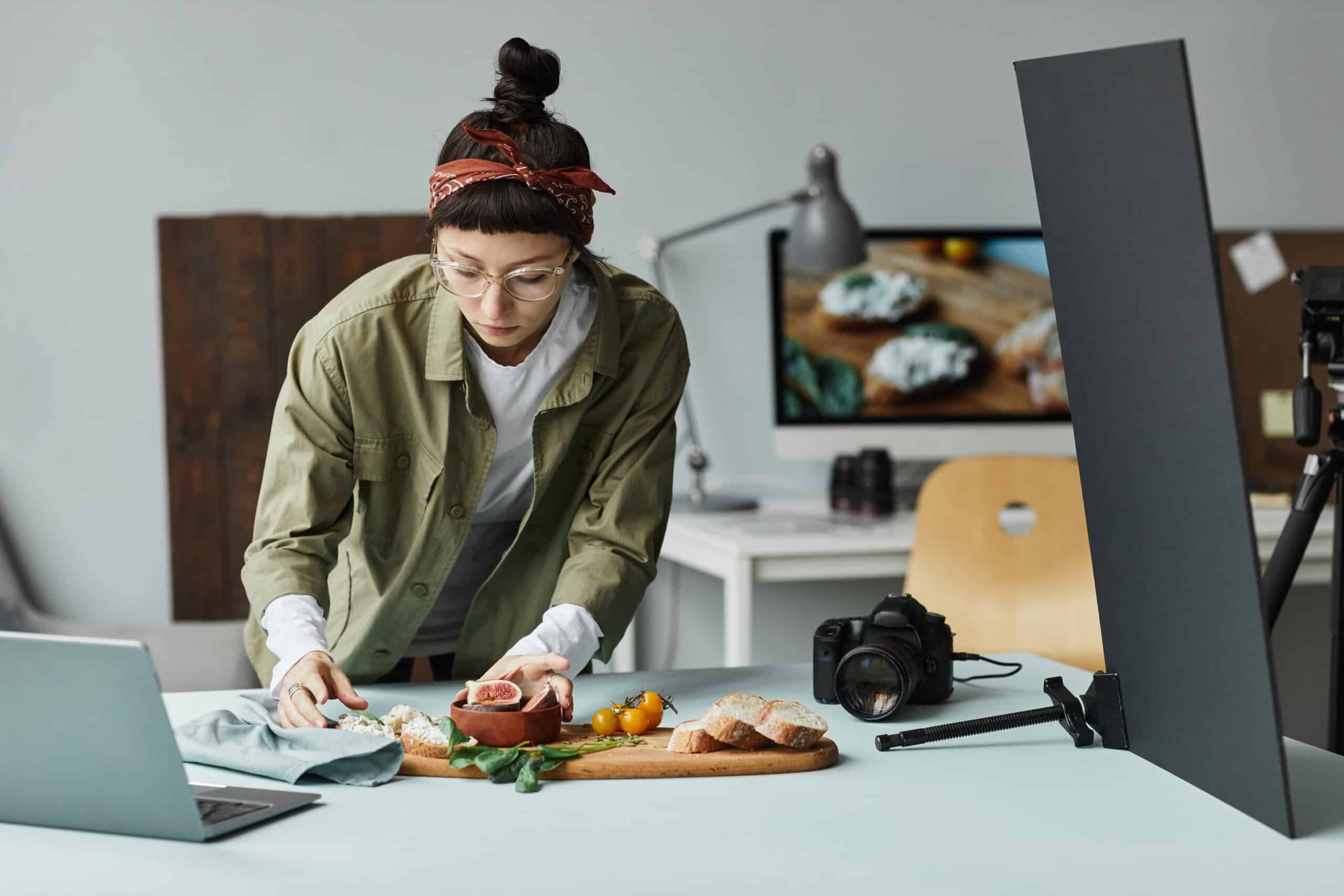 A female freelance recipe developer setting up a flatlay for a photoshoot